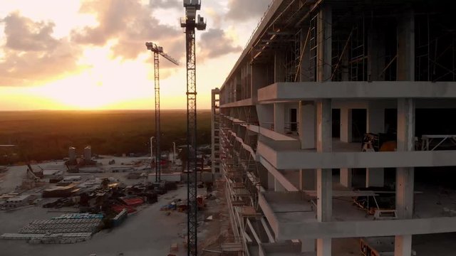 A high end hotel construction site next to the beach in Cancun, Mexico at sunset.
