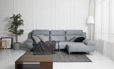Scandinavian style livingroom with fabric sofa, sofa table. morning image with plant. sofa table on...