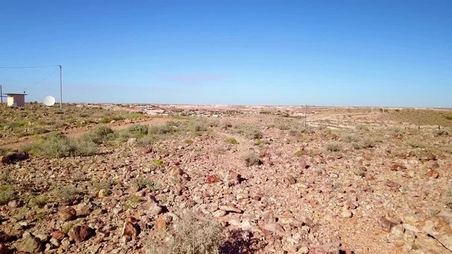 Aerial drone shot reveals the outback bush opal mining town of Coober Pedy, Australia.