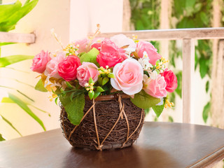 A bouquet of flowers in a wicker basket placed on the table looks beautiful. Floristry concept.