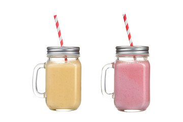 Refreshing smoothies in glass jars on a white background.