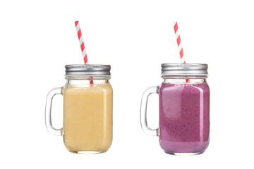 Refreshing delicious smoothies in glass jars on a white background.