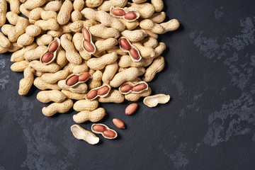 Organic peanut on black table, with copy space. Top view.