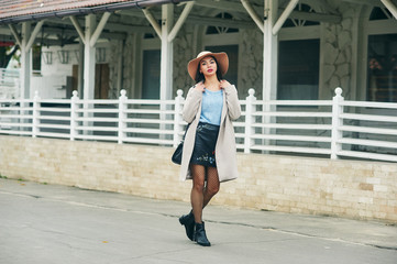 Obraz premium A young woman wears a wide-brimmed hat . Girl in town