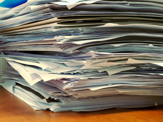 Pile of papers on office desk