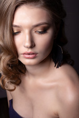 Fototapeta premium Portrait of a beautiful girl on a gray background.