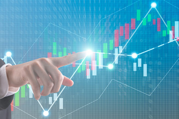 A Man hand and Display stock market investment trading , Business analyzing financial statistics Finance concept and success with technology