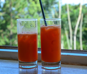 Watermelon juice in two glass bottles