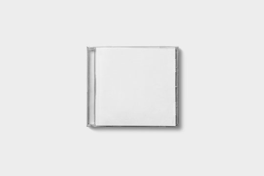 Closed compact plastic disc box case with white isolated blank for branding design. CD jewel mock-up on soft gray background.