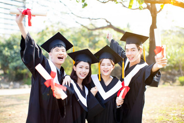 group of happy students celebrating graduation