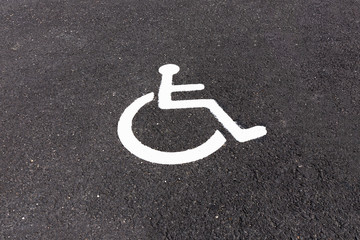 Wheelchair sign painted on disabled parking.