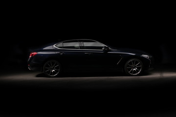 Four-door sport coupe. Silhouette of black sports car with headlights