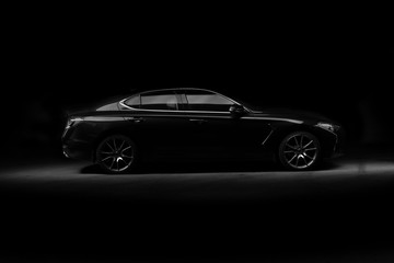 Plakat Four-door sport coupe. Silhouette of black sports car with headlights