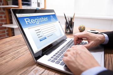 Man Filing Online Registration Form On Laptop
