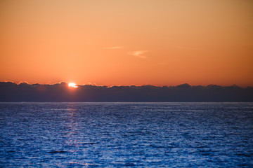 Sunrise or sunset over sea surface
