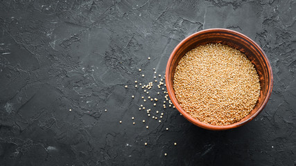 Raw white quinoa. On a black background. Top view. Free copy space.