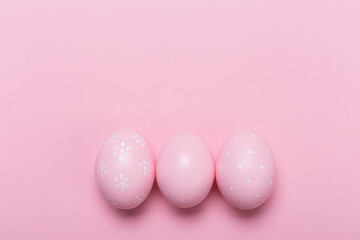 Fototapeta na wymiar Pink easter eggs in nest on pastel color background with space. Concept