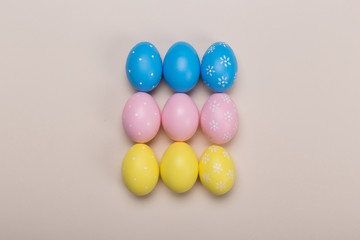 Colorfull easter eggs in nest on pastel color background with space. Concept