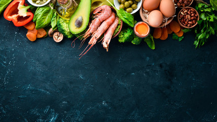 Healthy diet food: spinach, parsley, shrimp, pumpkin seeds, eggs, avocados, broccoli. Top view.