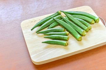 Pile of Fresh Okra on Wooden Board