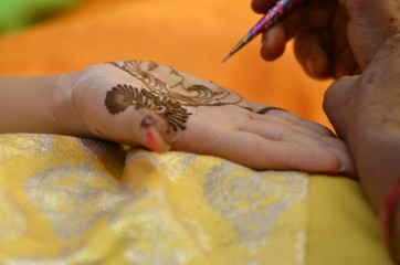 applying henna on hand, bride , traditional Hindu wedding , Rajasthan, India	