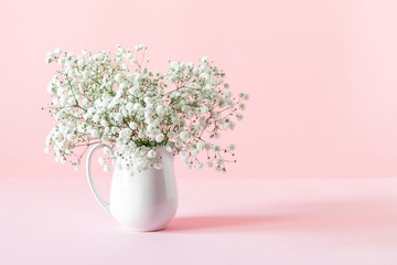 Home interior floral decor, white gypsophila flowers. Elegant floral soft pink composition....