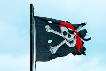 Ripped Jolly Roger Flag flying in the wind