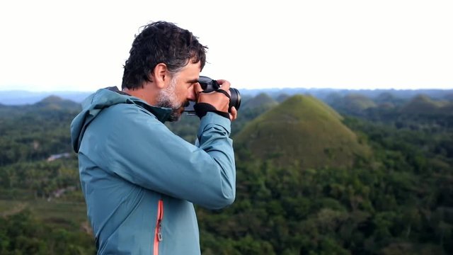 Photographer taking pictures in Chocolate Hills, Philippines