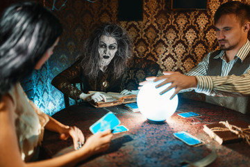 Young couple and fortune teller, spiritual seance