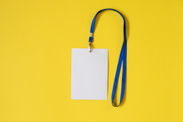 Empty ID card badge icon with blue belt, on yellow background. Space for text,  staff identity name tag template.