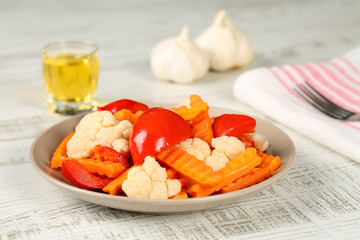 Traditional bulgarian starter - homemade pickled vegetables and a glass of grape rakia (brandy like strong alcohol drink)