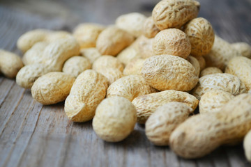 Peanuts in shells on a wooden table