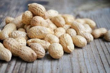 Peanuts in shells on a wooden table
