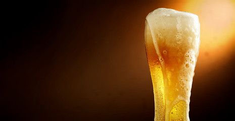 Cold beer and brown background with shadow 
