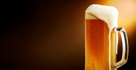 Cold beer and brown background with shadow 
