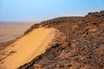 Sand dune on the west side of the holy mountain Jebel Bakal in Sudan