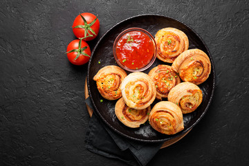 Rolls of puff pastry with bacon and cheese .