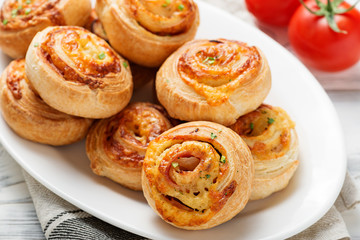 Obraz na płótnie Canvas Rolls of puff pastry with bacon and cheese .