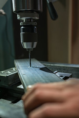 industrial milling machine at work while drilling steel and wood