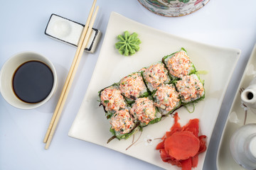 Sushi platter isolated on white background. Japanese food restaurant delivery - maki california rolls big party set, top view