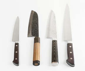 Four different knives on light gray surface