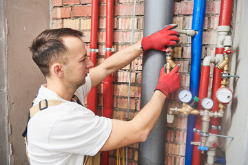 plumber installing and mounting water equipment - meter, filter and pressure reducer