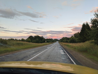 driving on a road with a sunset