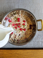 healthy breakfast with oatmeal, milk and berries