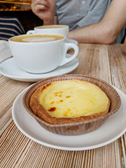 Pastel de nata and coffee on table