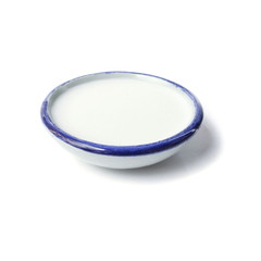 Coconut milk in a ceramic cup isolated on a white background.