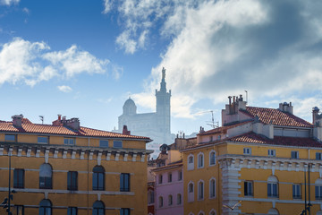 Obraz premium Basilique Notre-Dame de la Garde in the foggy background with red tiled roof Marseille houses