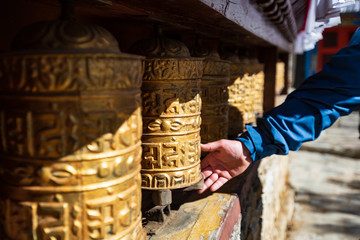 Nepal. Everest trekking. Tibetan prayer wheels in Boudhanath. Hand turns the wheel. On wheels...