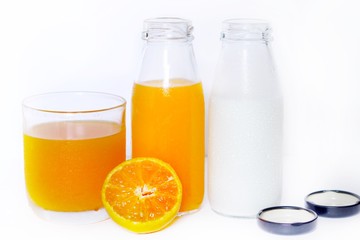 The Orange juice bottle with orange juice glass, half fresh orange and milk bottle isolated on white background
