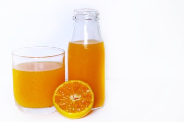 The Orange juice bottle with orange juice glass and a half fresh oranges isolated on white background 